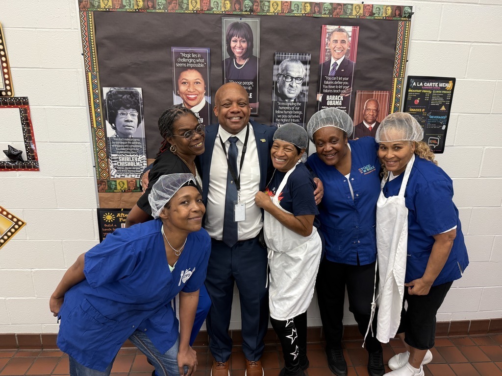 Dr. Yearwood poses for a picture with five nutrition services workers.