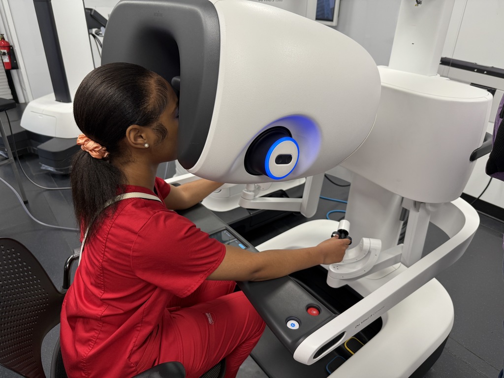 A student operates medical machinery.