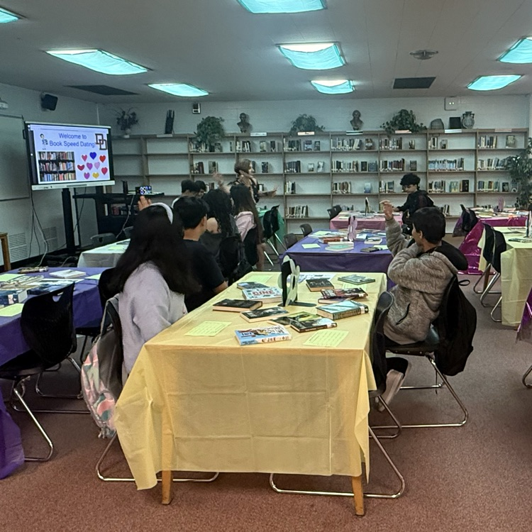 students at doss high school library, participating in book speed dating