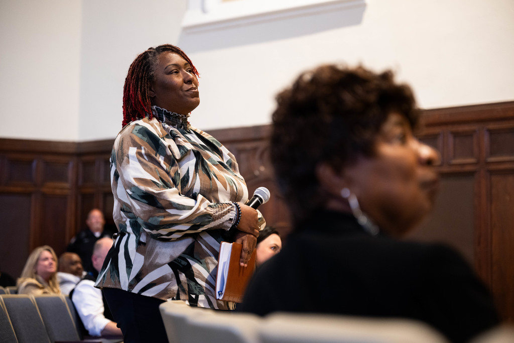 A community member listening to a response after asking Dr. Yearwood a question at a community forum. 