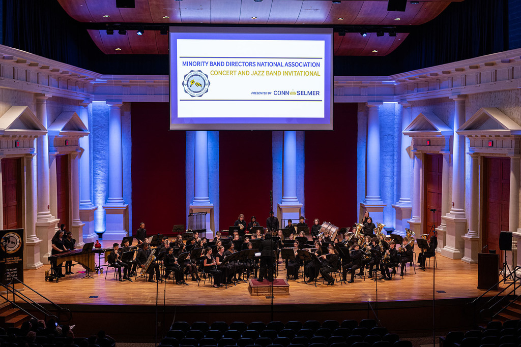 The Noe Middle School Band performs on a stage. 