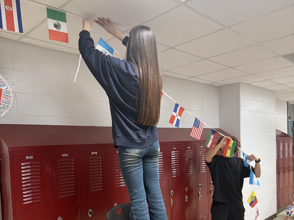 students hanging flags