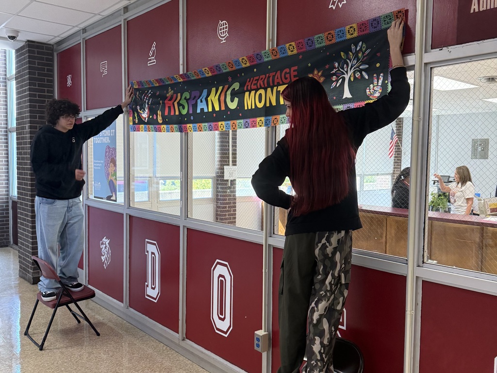 students hanging banners