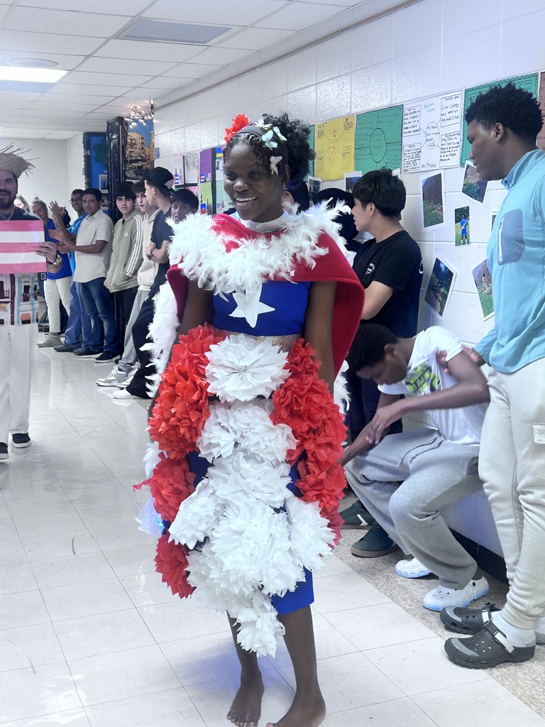 A student walks down a school hallway during a Hispanic Heritage event.