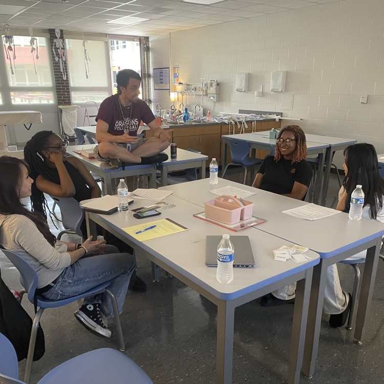 students sitting around table at first quick recall meet