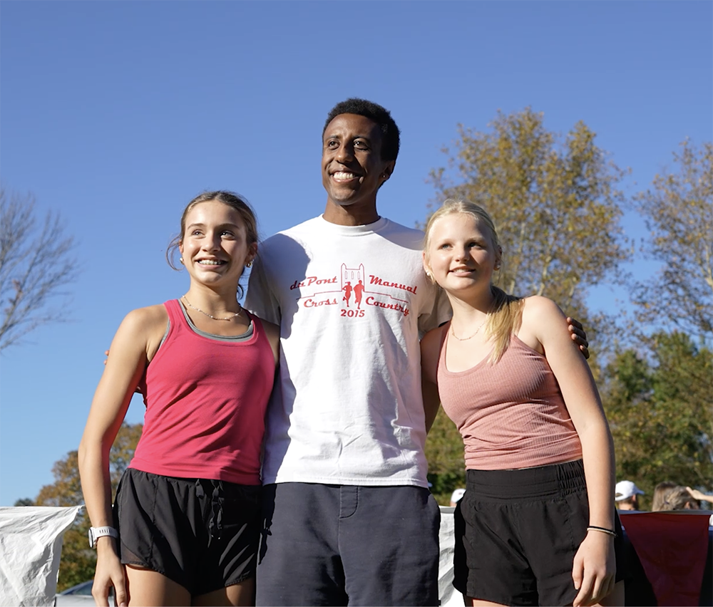 Yared Nuguse poses for a picture with students.