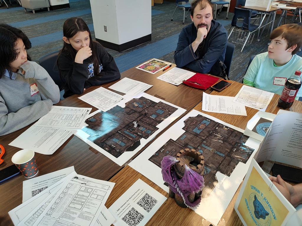 Dungeons and Dragon players deeply looking at the map and making some decisions!