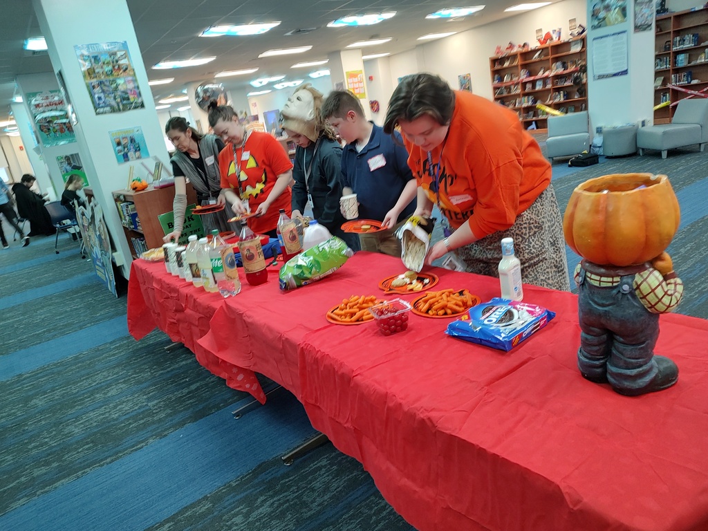 Table full of snacks with teachers and students grabbing some nourishment before starting to play some Dungeons and Dragons!