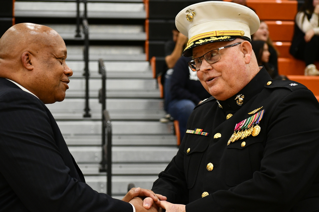 Dr. Yearwood shakes hands with a military official.