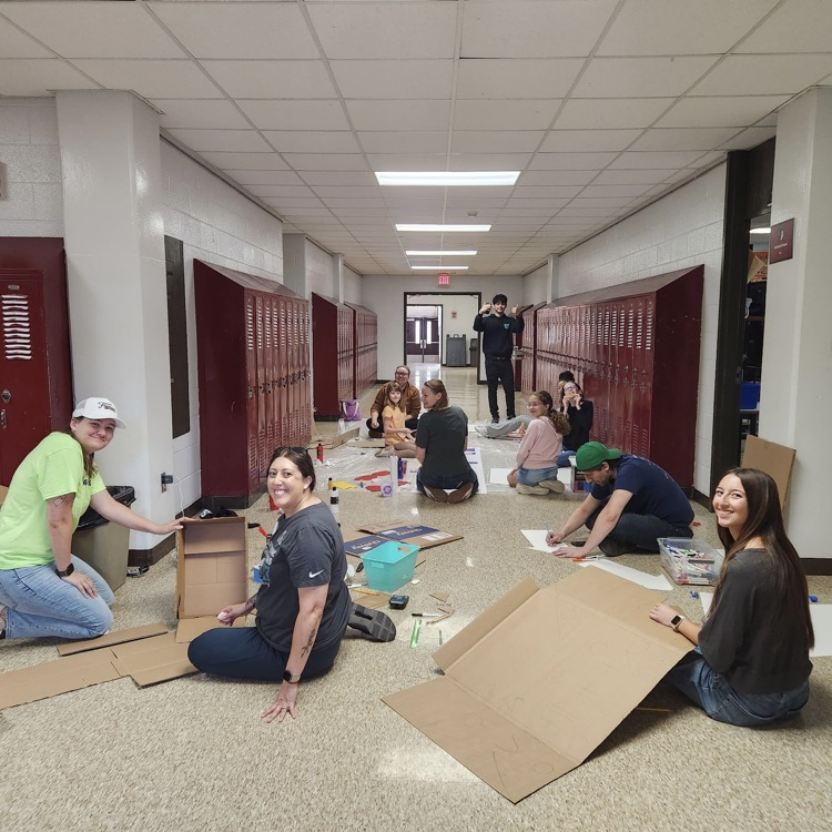teachers painting decorations in hallway