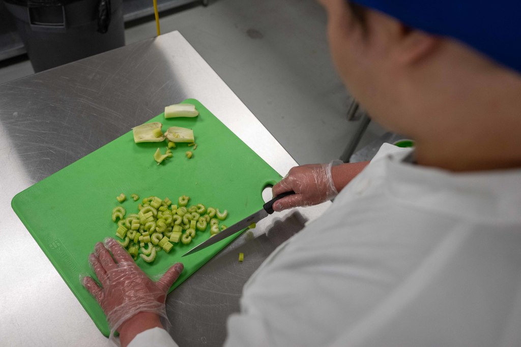 A student prepares food.