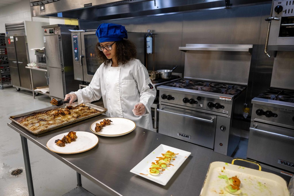 A student prepares food.