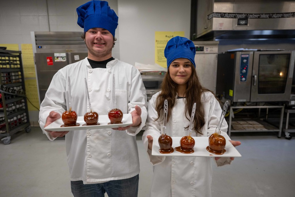 Students hold up prepared food.
