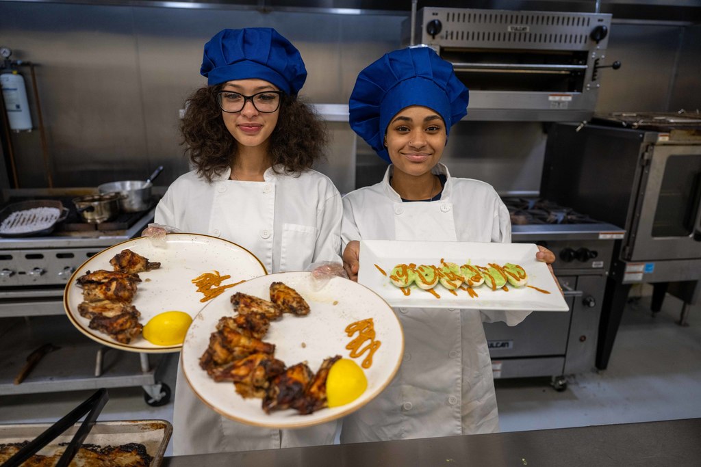 Students hold up prepared food.