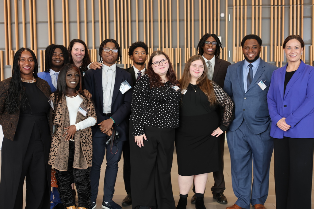 Students and adults pose for a picture.
