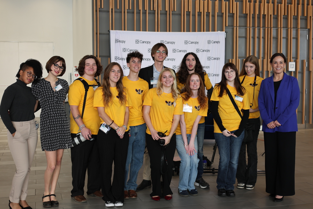 Students and adults pose for a picture.
