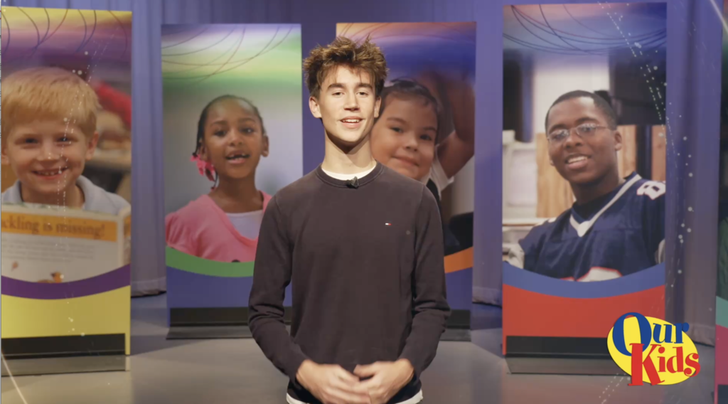 A student hosts the Our Kids TV show.