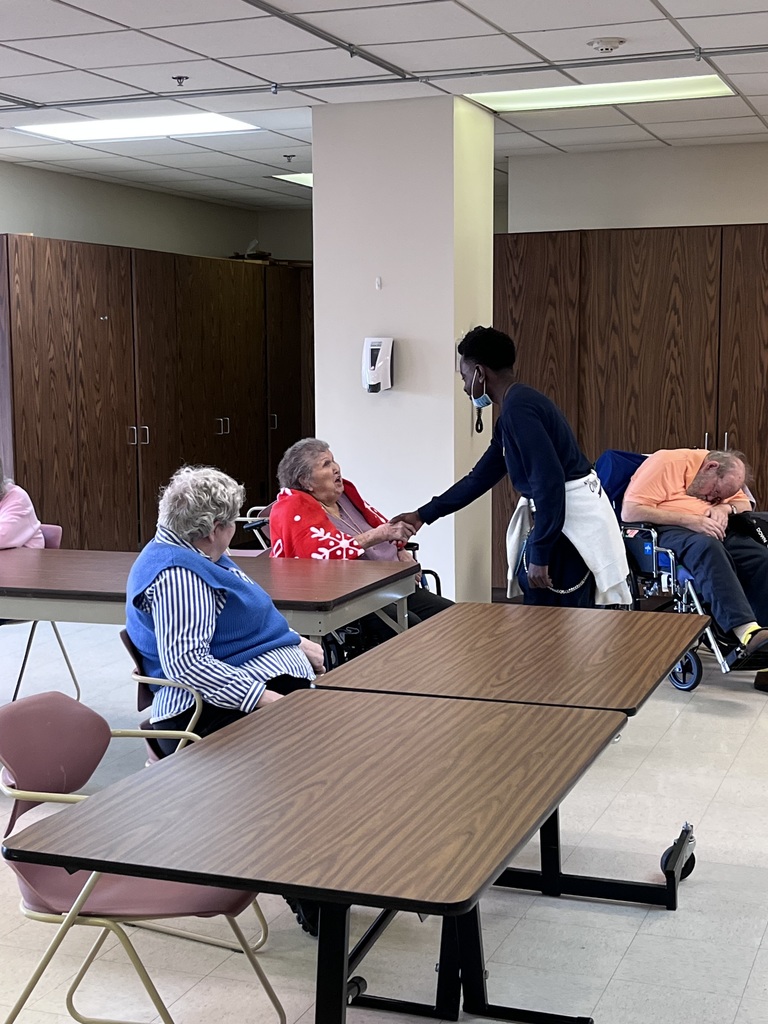 A student greets a resident.