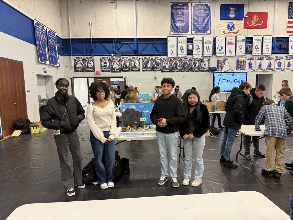 Students with their city project in the presentation area. 