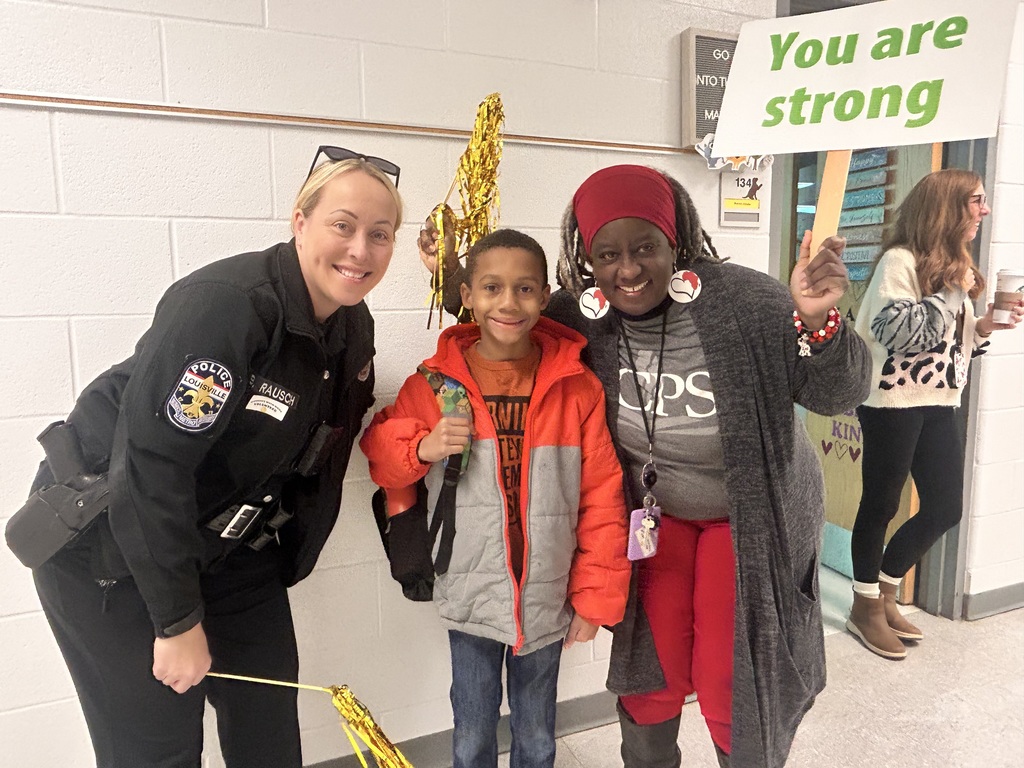 Two adults and a student pose for a picture and smile.
