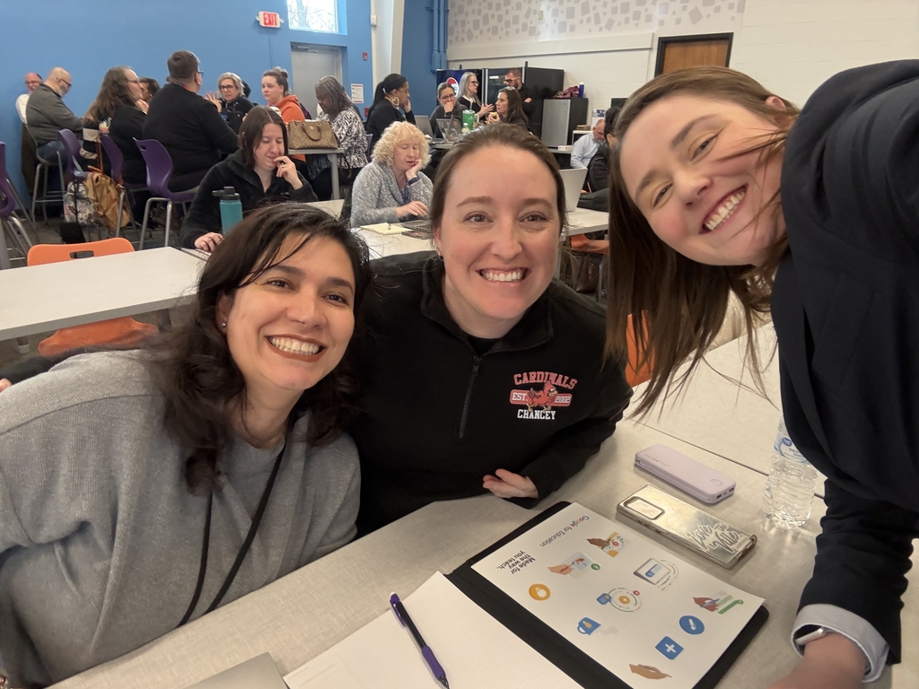 Three adults pose for a picture and smile. 