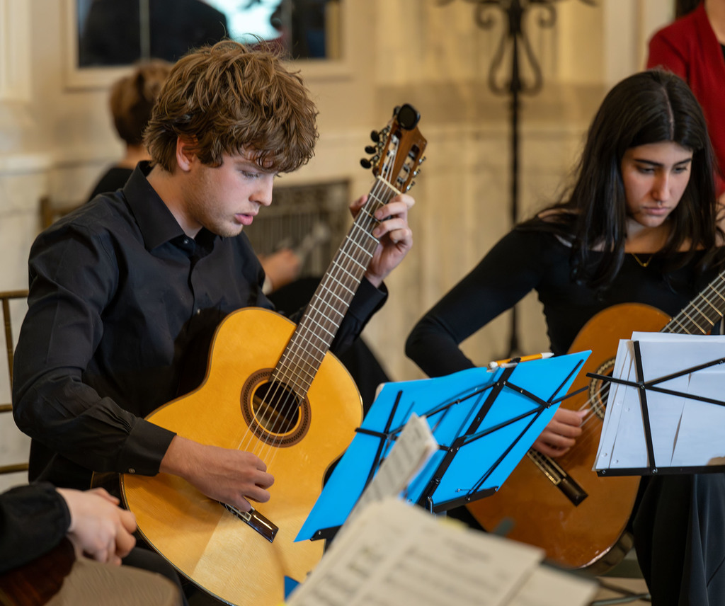 Students play guitars.