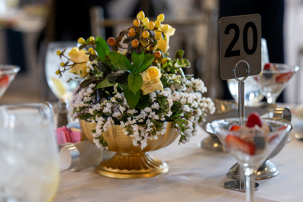 A floral arrangement sits on a table.