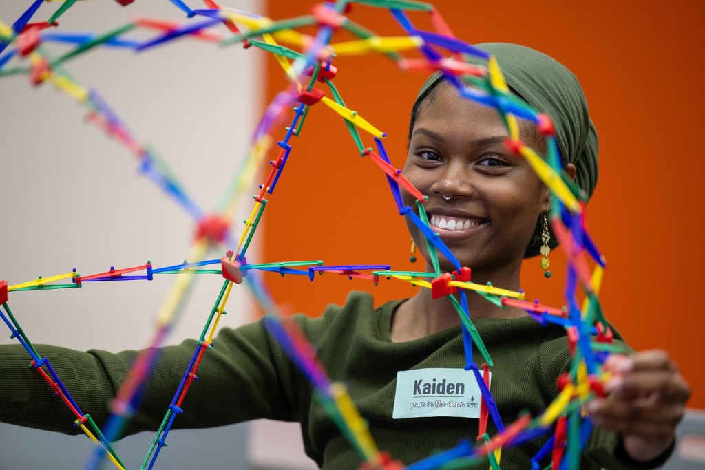 An adult plays with a stress ball. 
