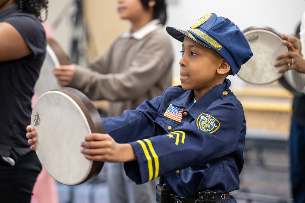 A student holds a drum.
