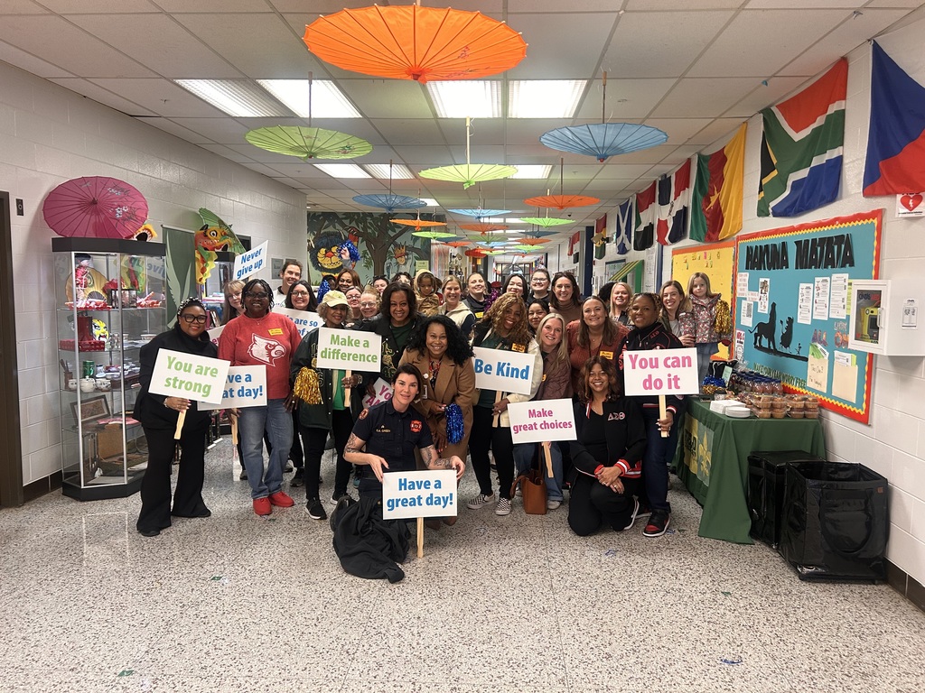 Mornings with Moms volunteers pose for a picture and smile.