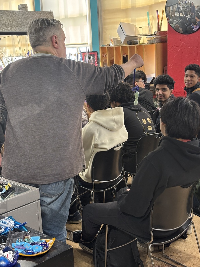 students interacting with local business owener