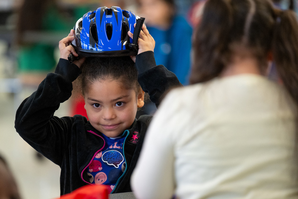 A student tries on a helmet.