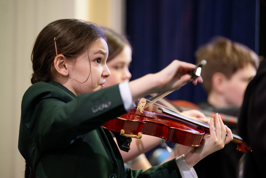 Students play instruments.