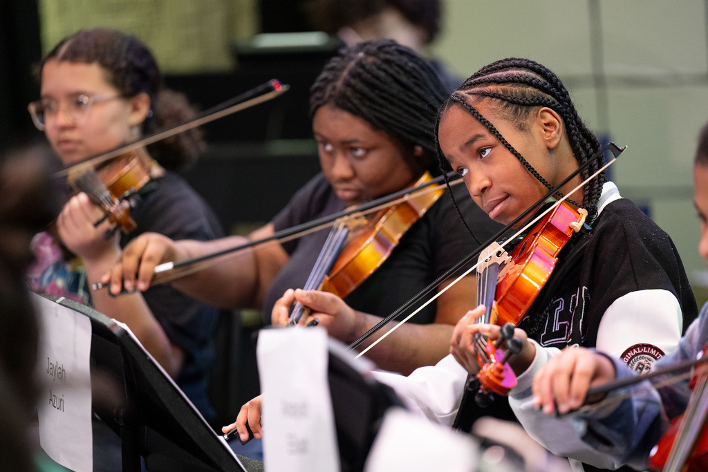 Students play instruments.