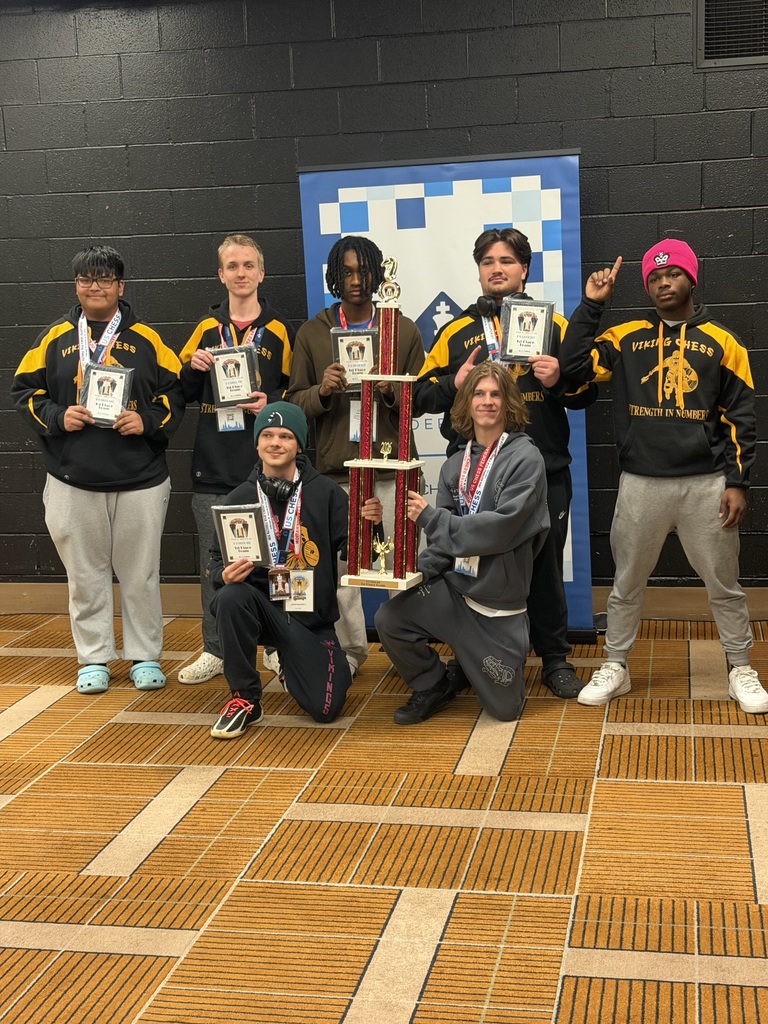 Six students pose for a picture while holding plaques and a trophy.