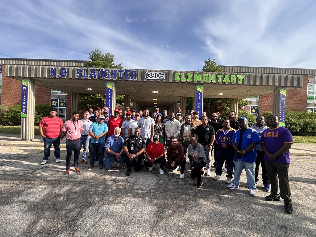 The JCPS Flash Dads pose for a picture and smile.