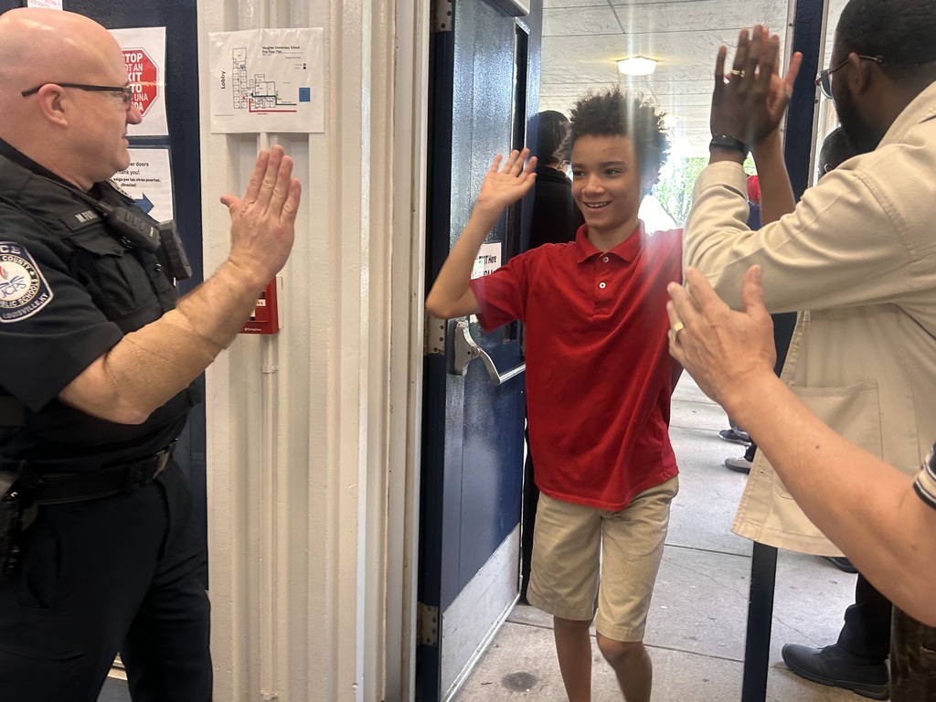 The JCPS Flash Dads cheer on students at Slaughter Elementary.