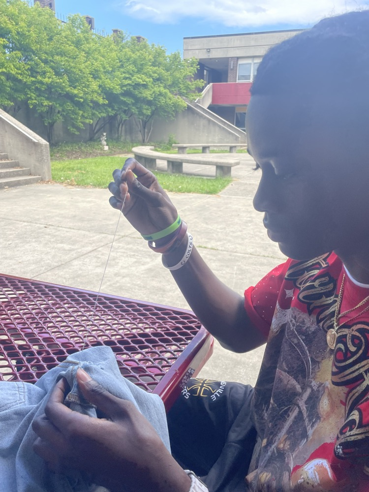 student learning to sew