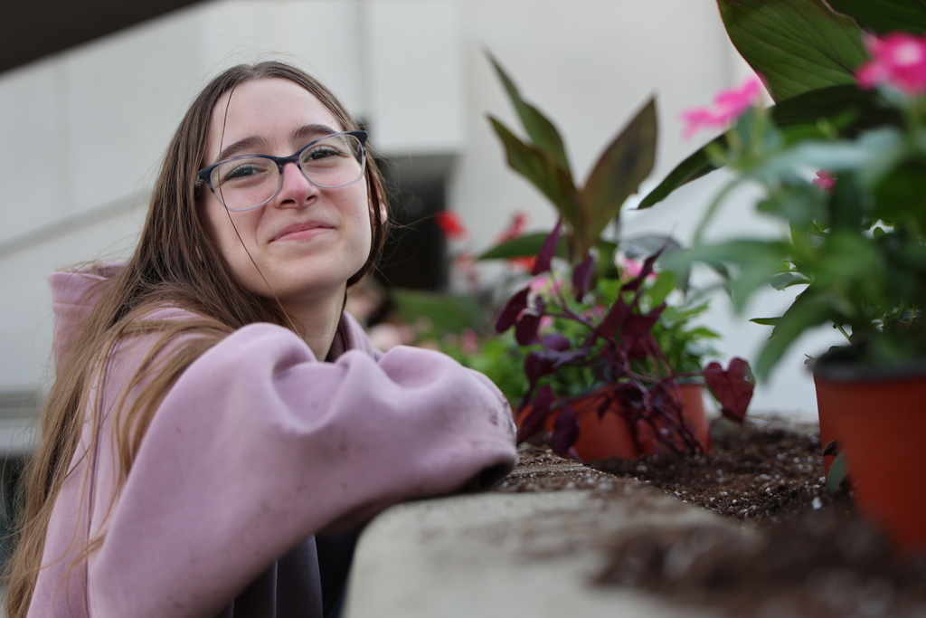 A student plants flowers.