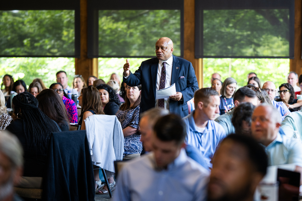 Superintendent Dr. Brian Yearwood talks to a group of staff.