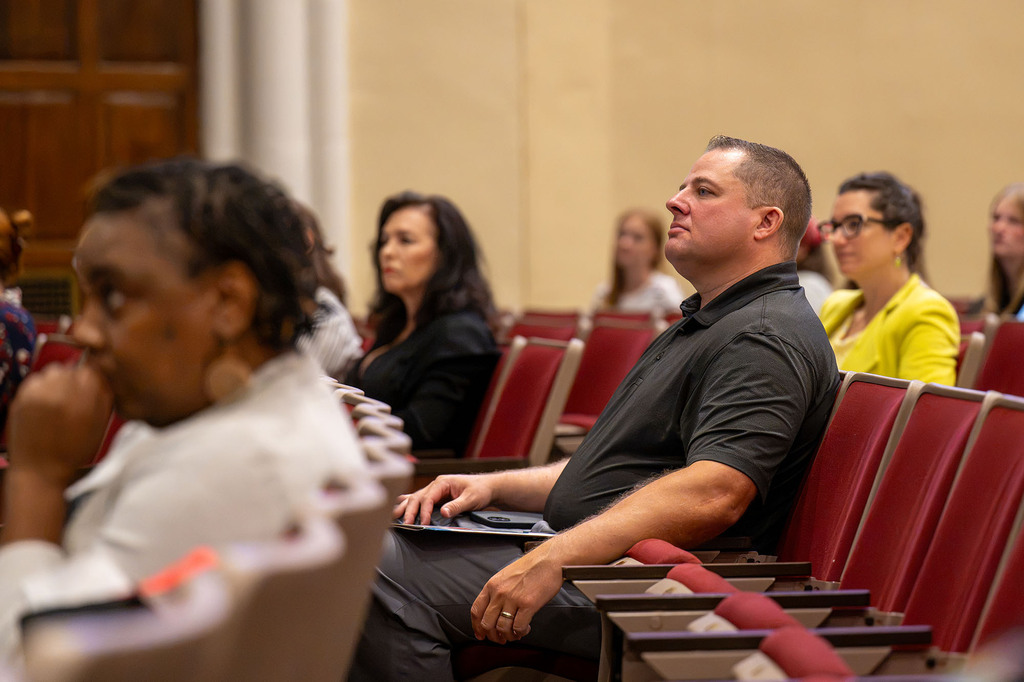 A man sits in the crowd.
