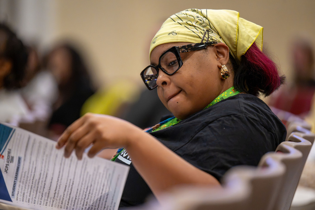 A woman looks at JCPS 101 materials.