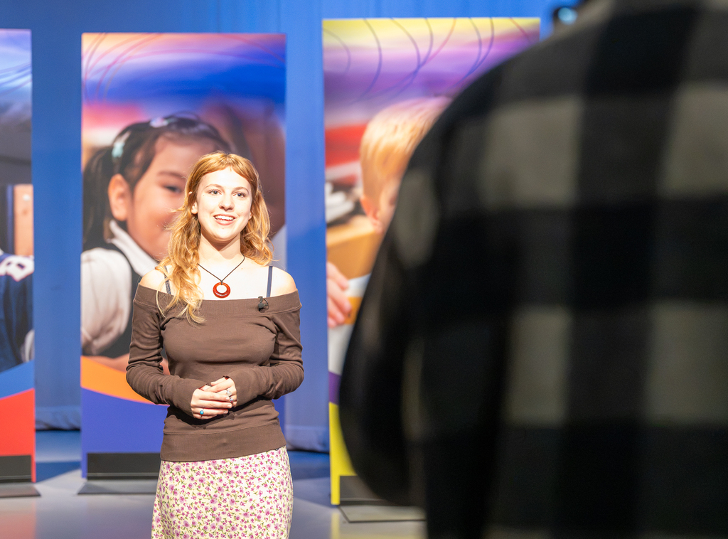Two video coordinators work with a student to produce the "Our Kids" TV show.