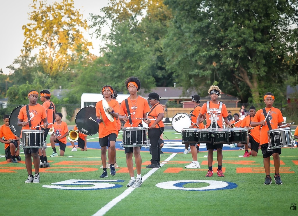 A student drum-line performs.