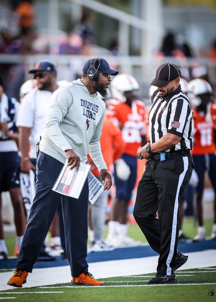 A coach talks to a referee. 