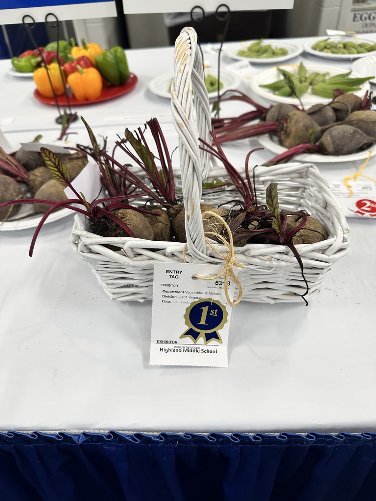 A basket of vegetables sits on a table.