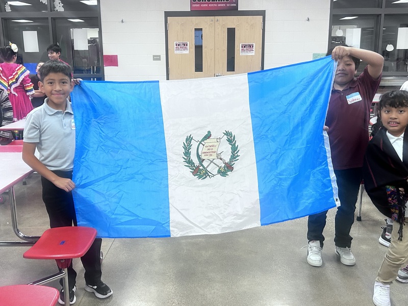 Two students holding a flag