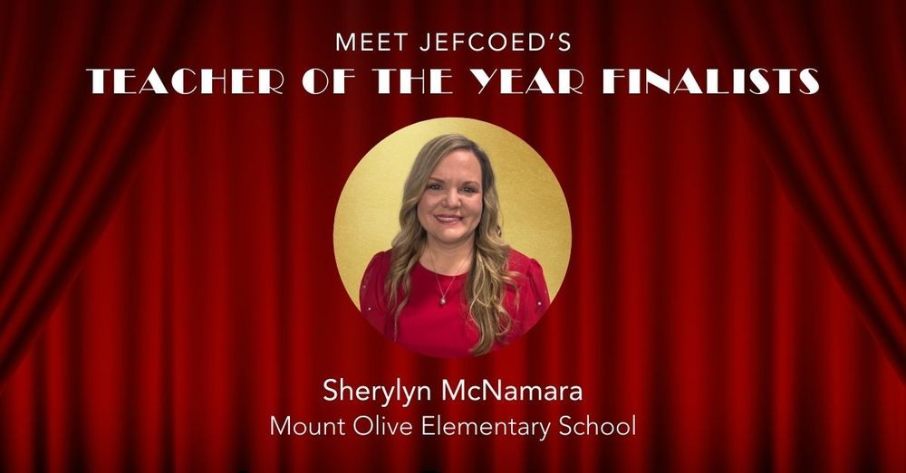 Image is a graphic that says "Meet JEFCOED's Teacher of the Year Finalists" Under the text is a photo of Sherylyn McNamara. Below her photo, her name is typed out, along with the school she teaches at, Mount Olive Elementary School. The text and headshot is placed over a red curtain background.
