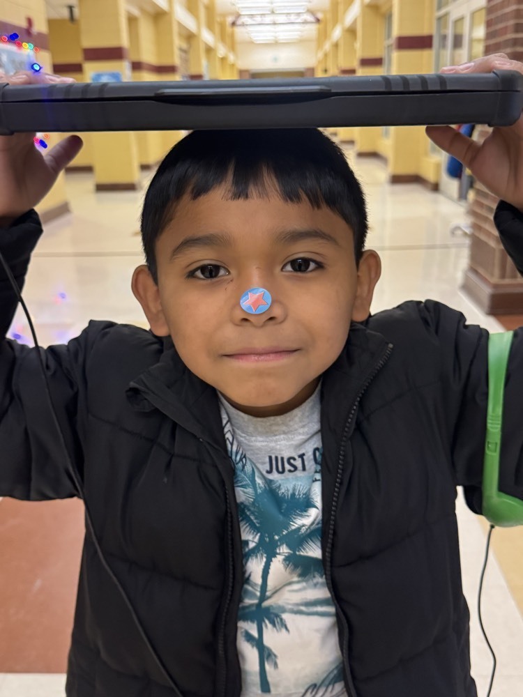 kid with a sticker on his nose
