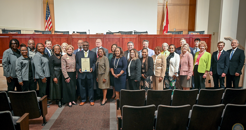 Large group of supporters, colleagues,  and educators stand with Dr. Walter Gonsoulin for a picture as he is recognized at the Alabama Board of Education Meeting for being the named the 2025 National Superintendent of the Year. 